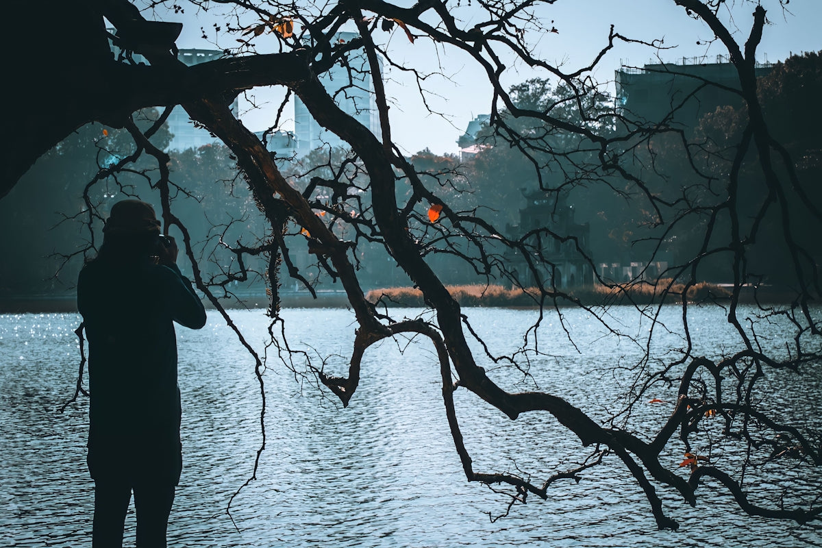 a person standing next to a body of water